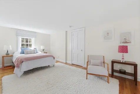 a bedroom with a bed and a chair