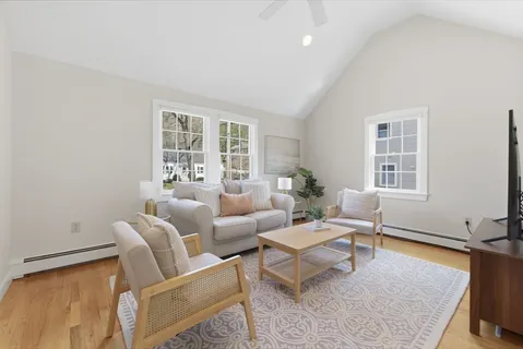 a living room with furniture lamp and window