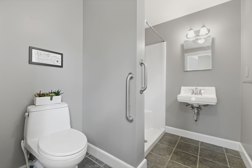 31 Fuller Road Lexington, MA 02420 - Photo 36 of 42 a bathroom with a toilet a sink and mirror