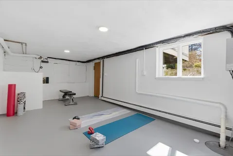 a room with gym equipment and a table