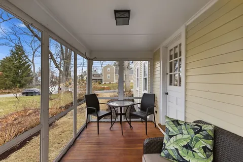 a dining room with furniture window and wooden floor