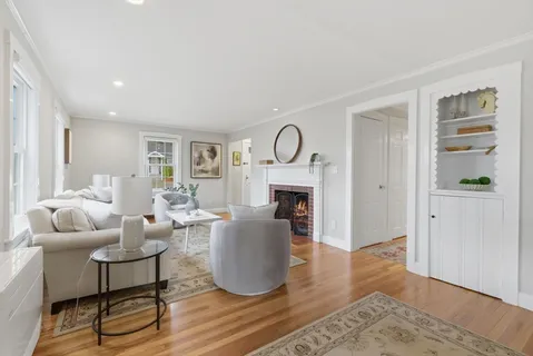 a living room with furniture a fireplace and a table