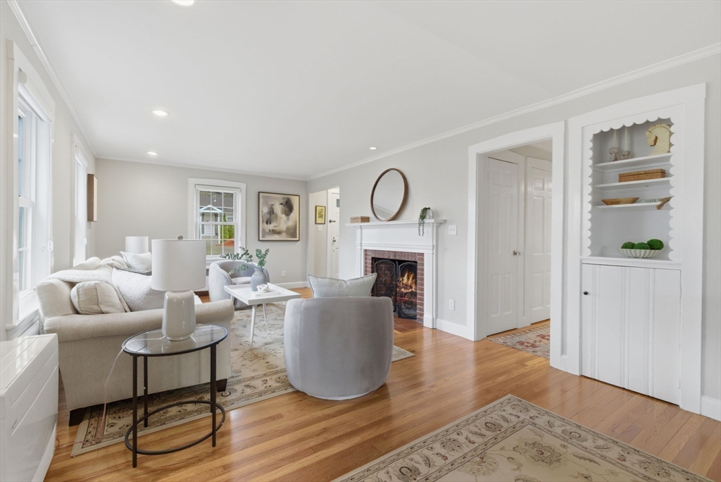 31 Fuller Road Lexington, MA 02420 - Photo 8 of 42 a living room with furniture a fireplace and a table