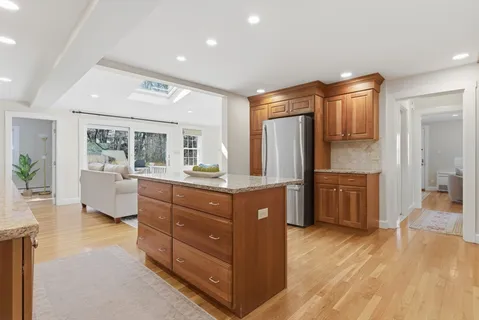 a kitchen with sink cabinets and wooden floor