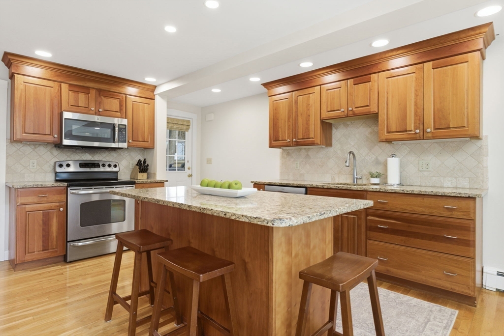 31 Fuller Road Lexington, MA 02420 - Photo 10 of 42 a kitchen with stainless steel appliances granite countertop a stove top oven a sink a counter space and cabinets