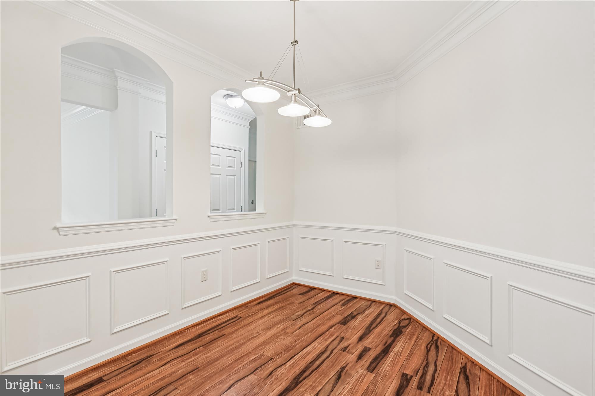 23 Arch Place, Unit 273 Gaithersburg, MD 20878 - Photo 12 of 103 a view of an empty room with wooden floor and a window