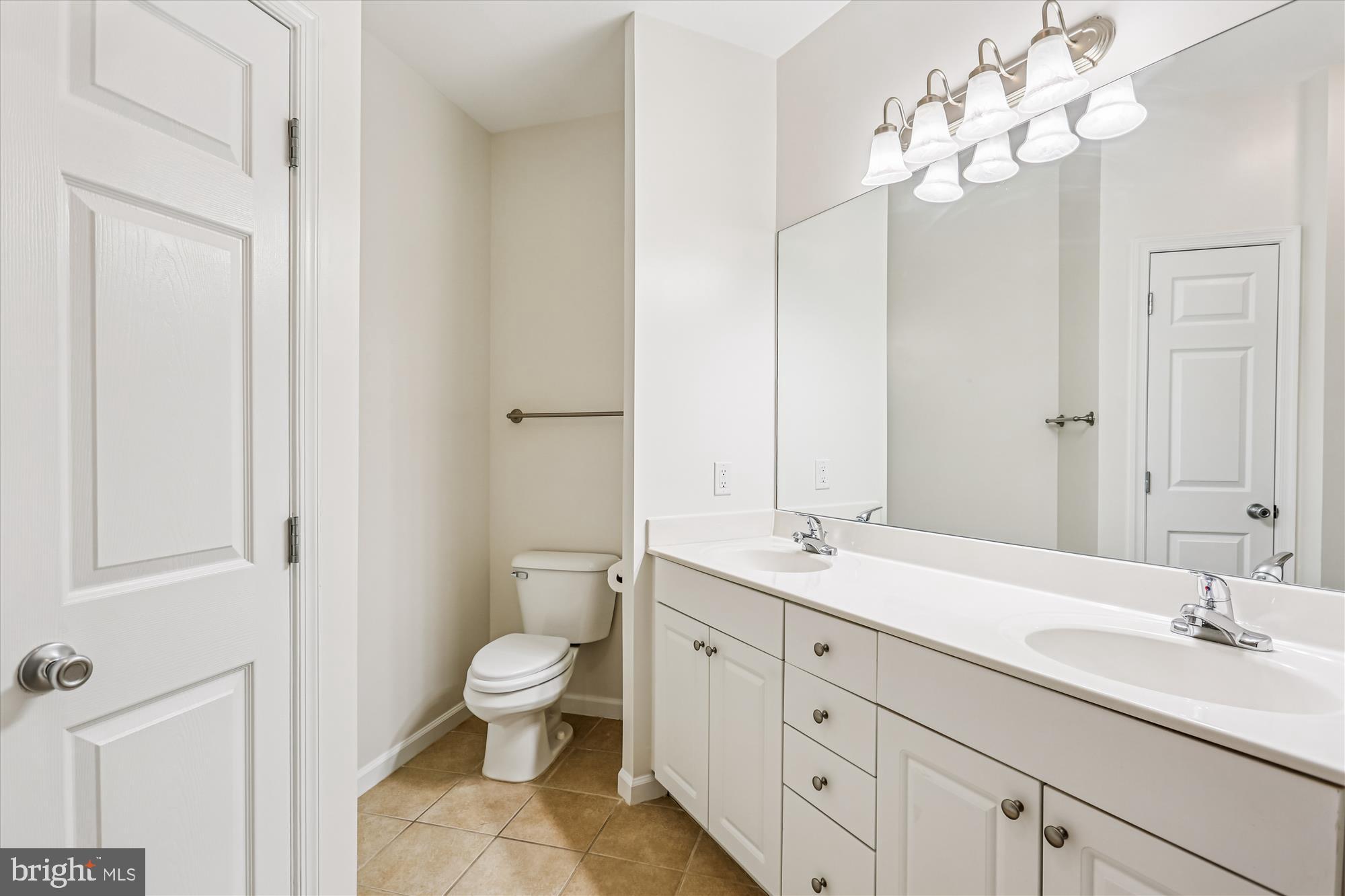 23 Arch Place, Unit 273 Gaithersburg, MD 20878 - Photo 30 of 103 a spacious bathroom with a granite countertop sink a toilet and a mirror