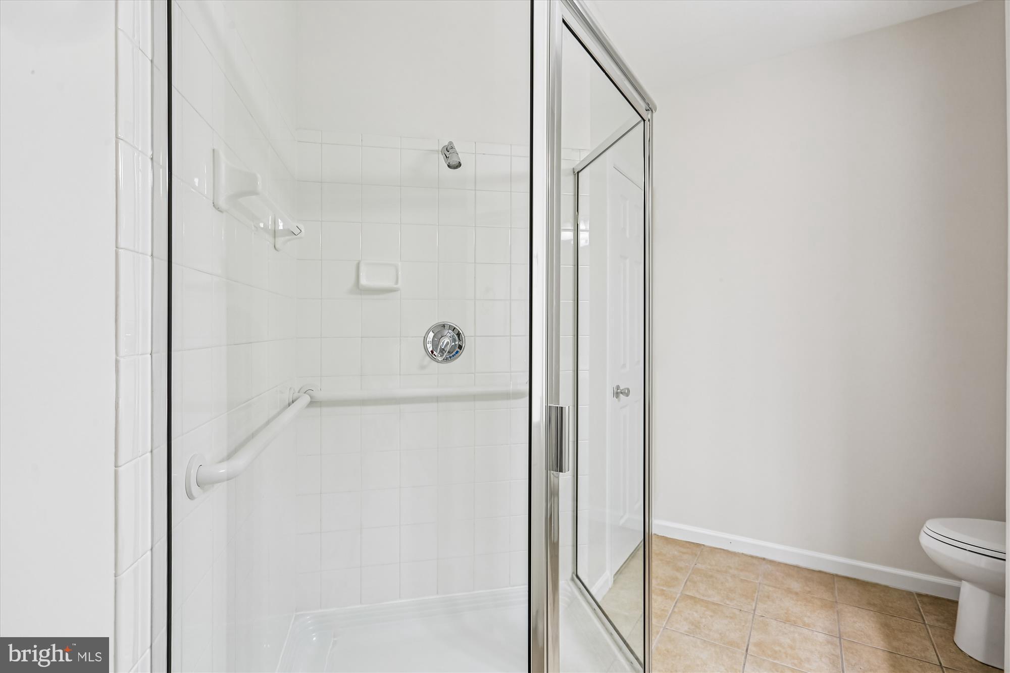23 Arch Place, Unit 273 Gaithersburg, MD 20878 - Photo 39 of 103 a bathroom with a granite countertop shower and a toilet