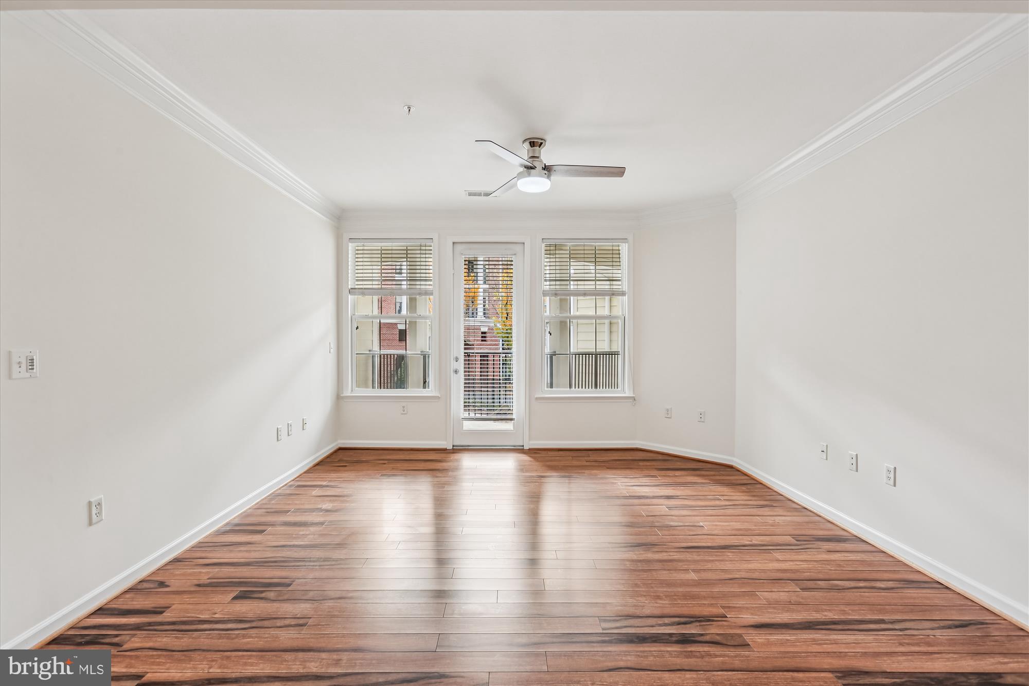 23 Arch Place, Unit 273 Gaithersburg, MD 20878 - Photo 4 of 103 an empty room with wooden floor chandelier fan and windows