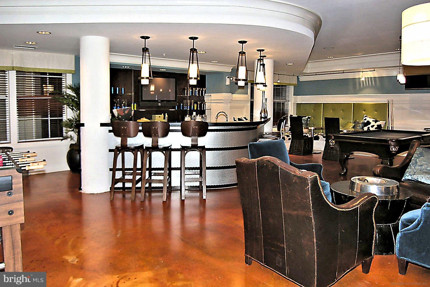 23 Arch Place, Unit 273 Gaithersburg, MD 20878 - Photo 63 of 103 a kitchen with stainless steel appliances granite countertop a stove top oven a dining table and chairs with wooden floor