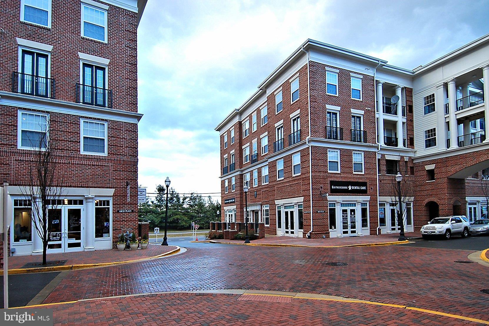 23 Arch Place, Unit 273 Gaithersburg, MD 20878 - Photo 75 of 103 a front view of a building with lot of cars and trees
