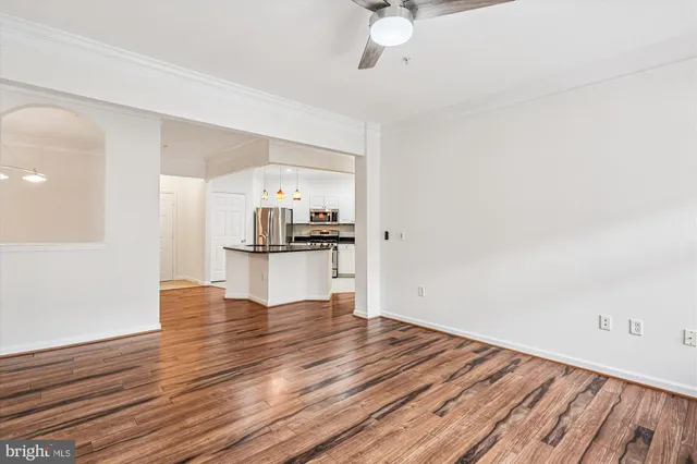 a kitchen with stainless steel appliances white cabinets a stove a microwave and a refrigerator