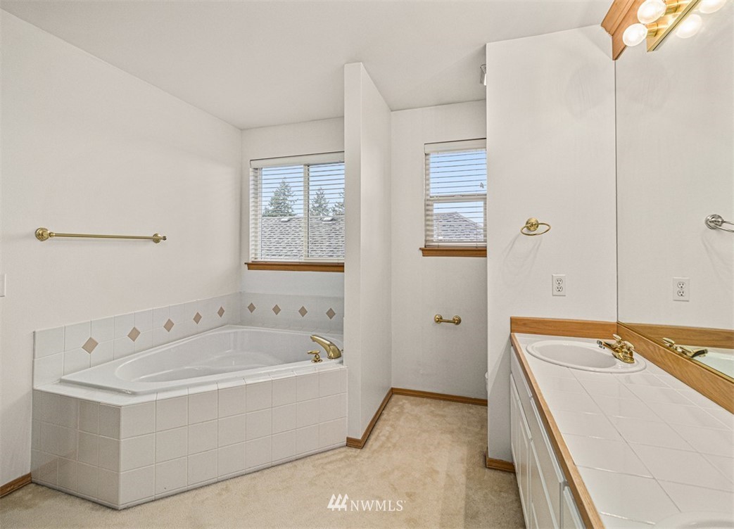 3518 Northeast 24th Court Renton, WA 98056 - Photo 14 of 17 a bathroom with a tub sink and mirror
