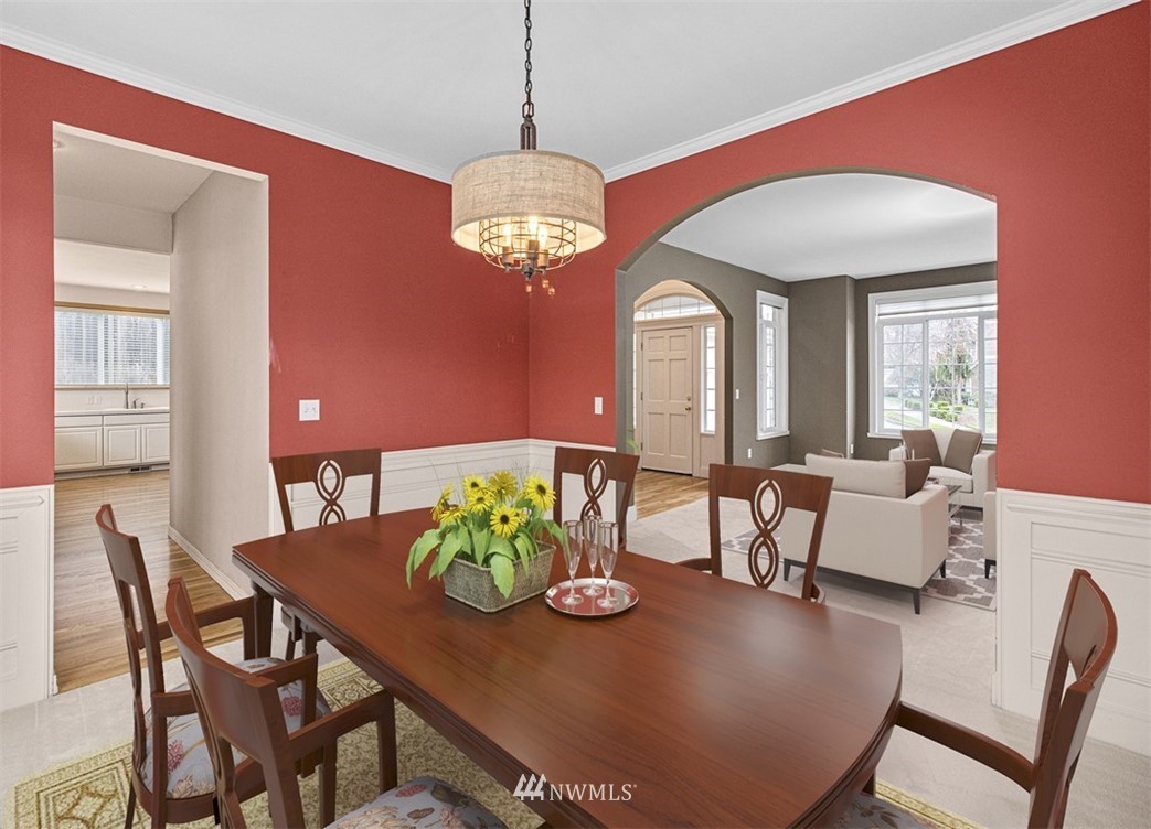 3518 Northeast 24th Court Renton, WA 98056 - Photo 6 of 17 a view of a dining room with furniture a chandelier and wooden floor