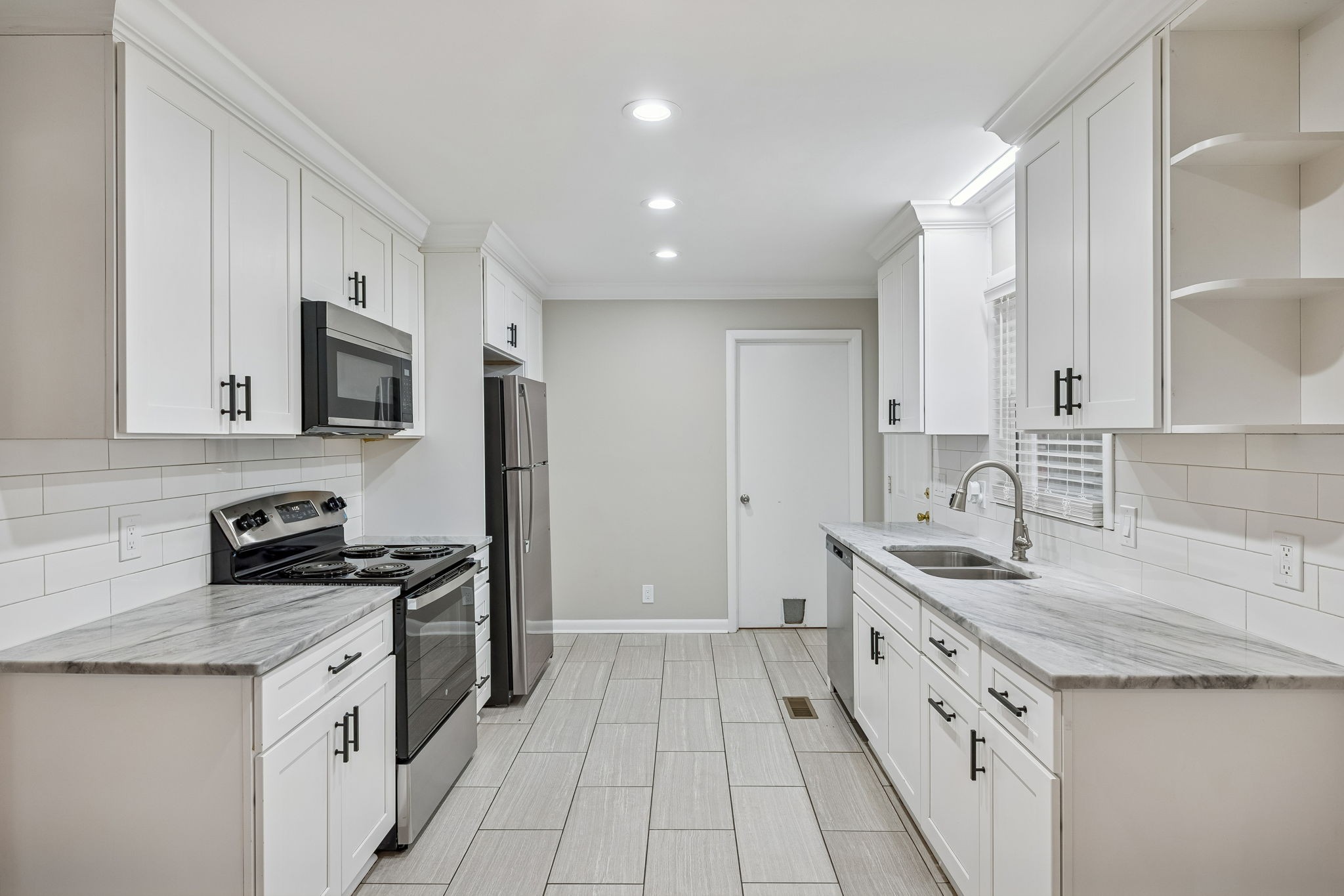 111 Chestnut Street Smyrna, TN 37167 - Photo 13 of 41 a kitchen with stainless steel appliances granite countertop a sink stove and refrigerator