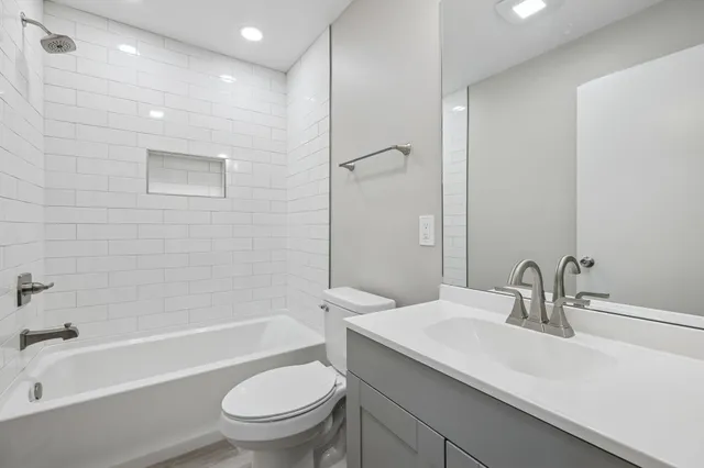 a bathroom with a sink a toilet and a bathtub