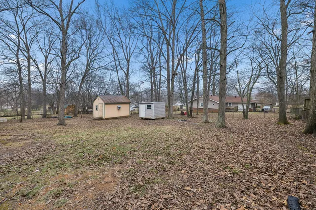 a backyard of a house with trees and outdoor space