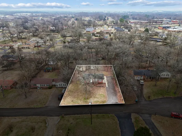 an aerial view of residential houses with outdoor space