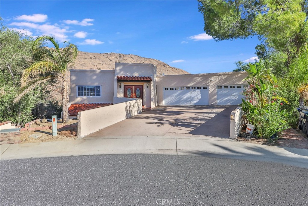 a view of a house with a road and a yard