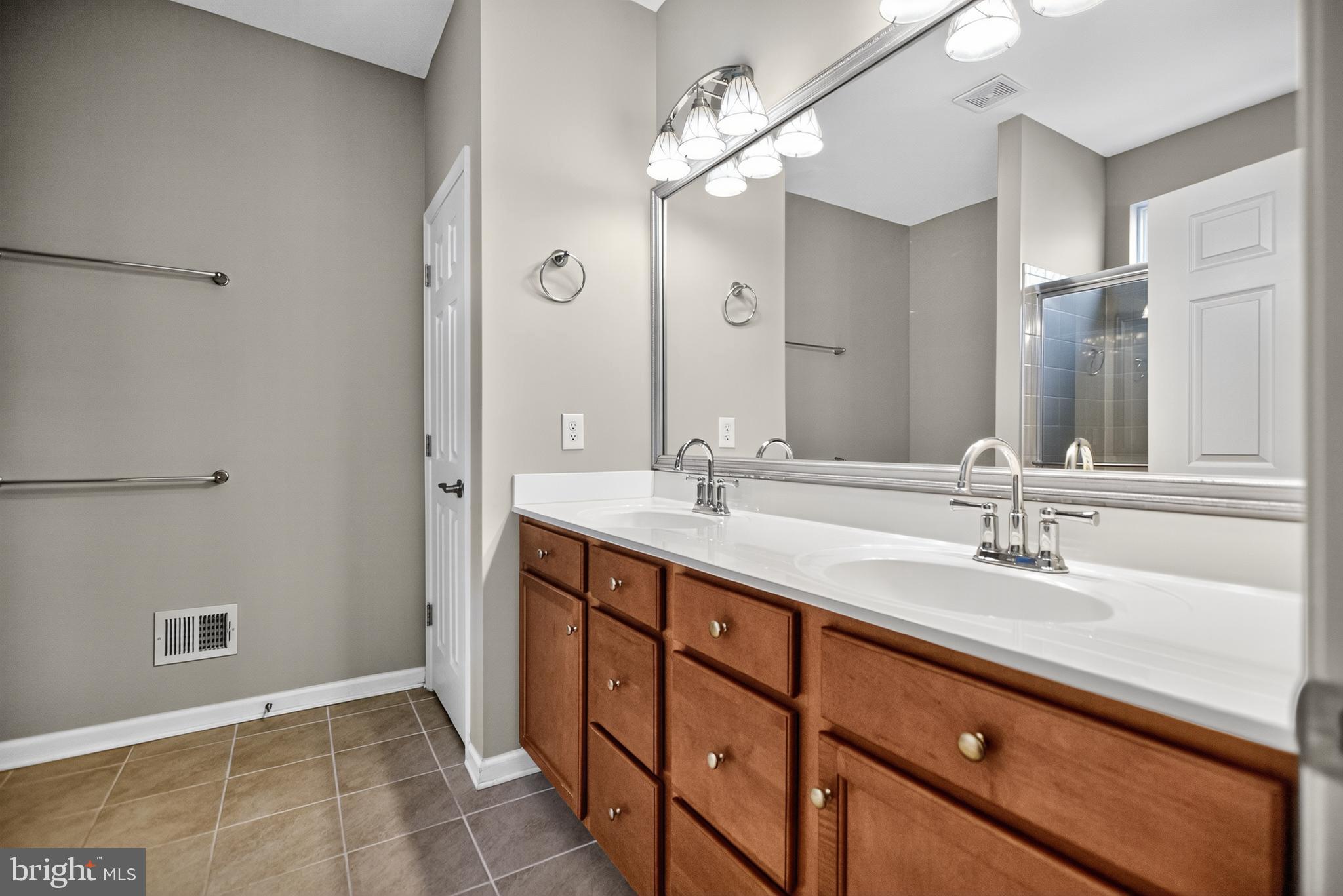 32 Montauk Avenue Fredericksburg, VA 22406 - Photo 23 of 30 a bathroom with a double vanity sink and a mirror