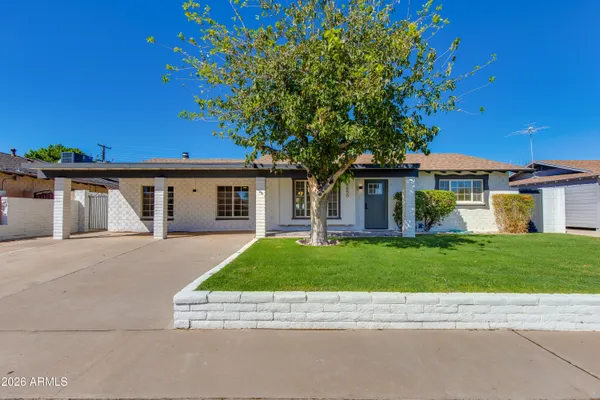 front view of a house with a garden
