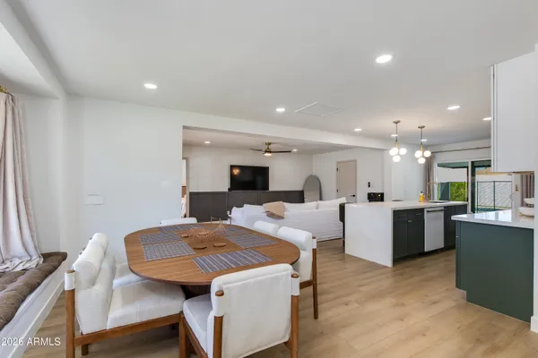 a view of a dining room with furniture and wooden floor