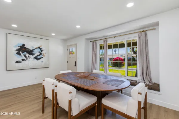 a kitchen with kitchen island granite countertop a sink cabinets and wooden floor