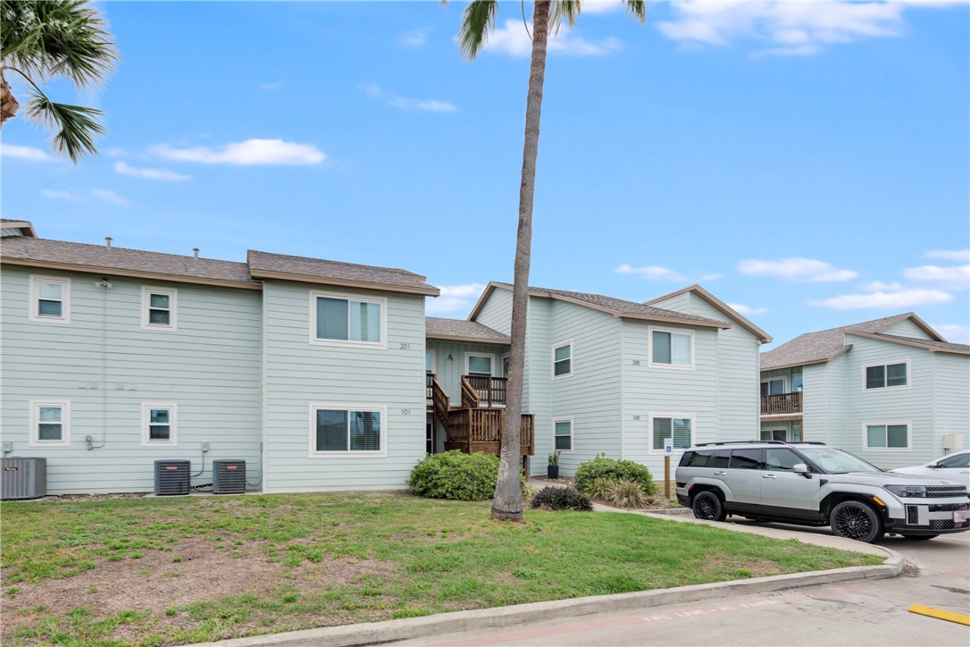 230 Cut-Off Road, Unit 101 Port Aransas, TX 78373 - Photo 2 of 30 a house view with a garden space