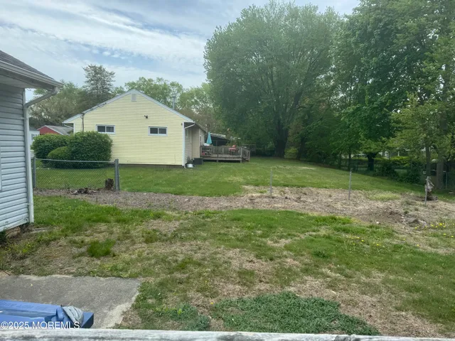 a view of a house next to a yard and trees