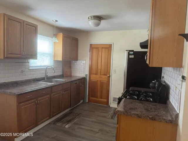 a kitchen with a sink stove and refrigerator