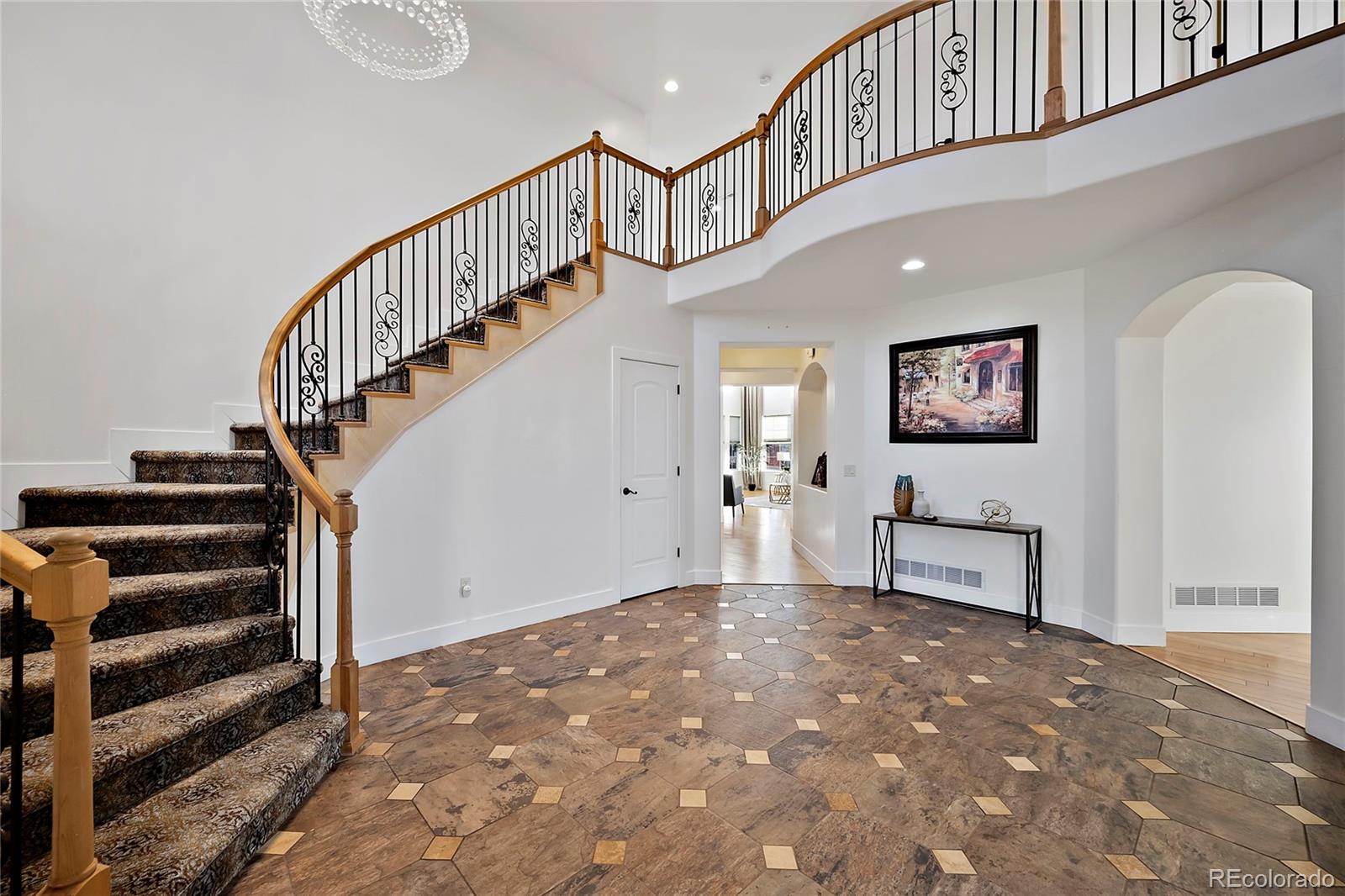 16520 East Easter Way Foxfield, CO 80016 - Photo 13 of 38 a view of entryway with stairs and wooden floor