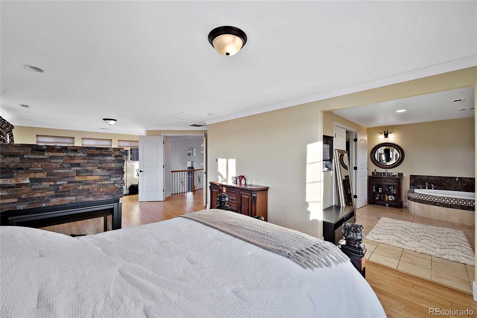 16520 East Easter Way Foxfield, CO 80016 - Photo 17 of 38 a bedroom with a bed and a dresser