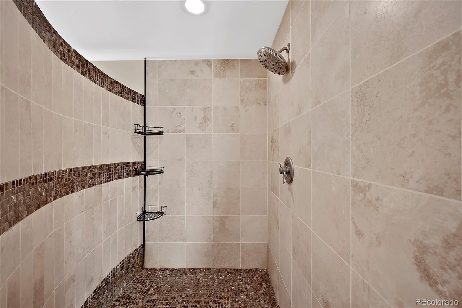 16520 East Easter Way Foxfield, CO 80016 - Photo 19 of 38 a bathroom with a shower