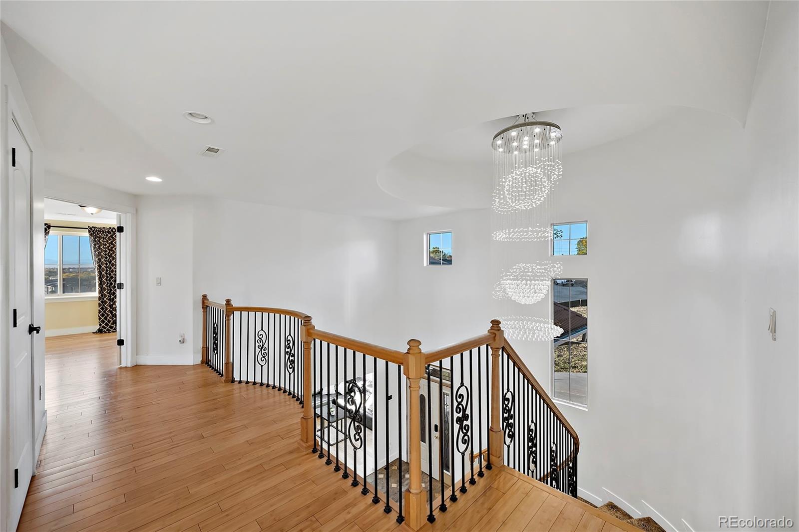 16520 East Easter Way Foxfield, CO 80016 - Photo 21 of 38 a view of staircase with railing and white walls