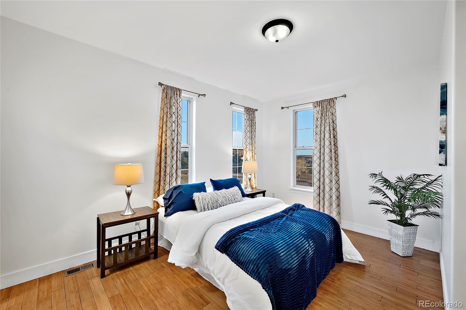 16520 East Easter Way Foxfield, CO 80016 - Photo 23 of 38 a bedroom with a bed and a potted plant