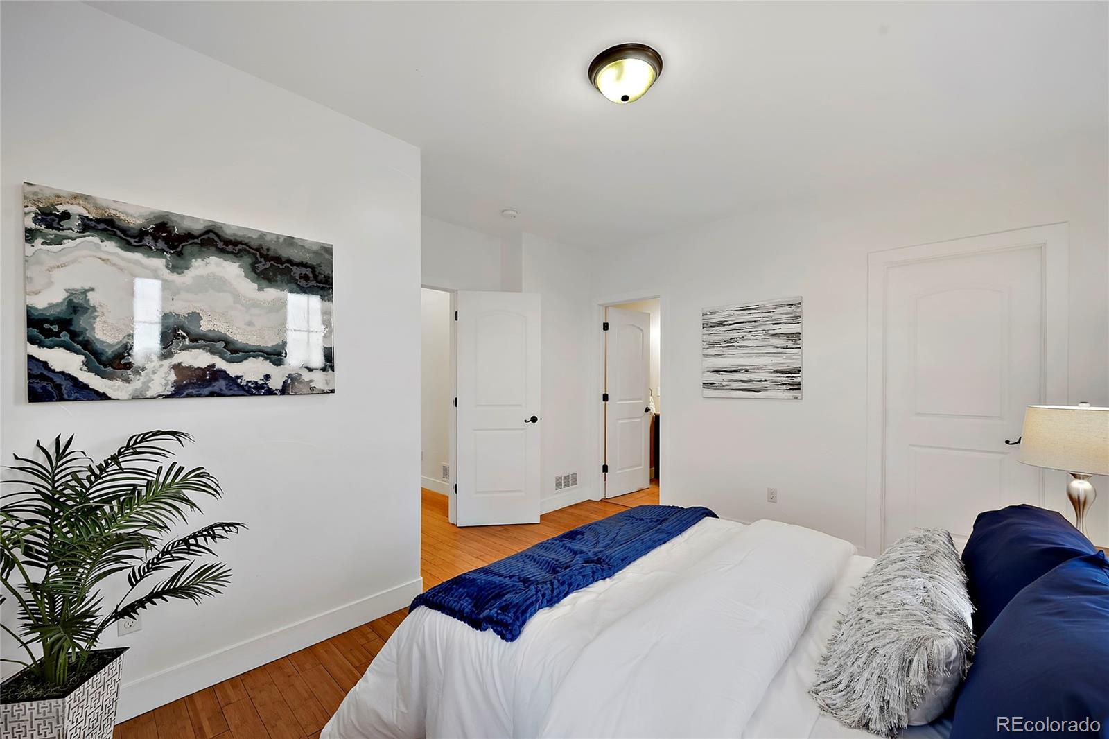 16520 East Easter Way Foxfield, CO 80016 - Photo 24 of 38 a bedroom with a bed and a painting on the wall