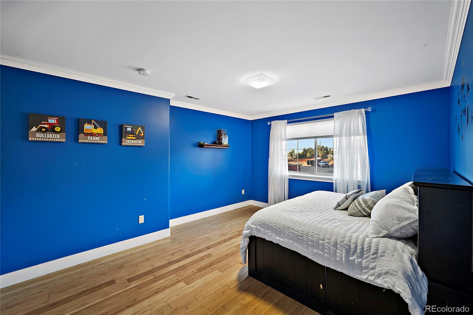 16520 East Easter Way Foxfield, CO 80016 - Photo 29 of 38 a bedroom with a bed and a window