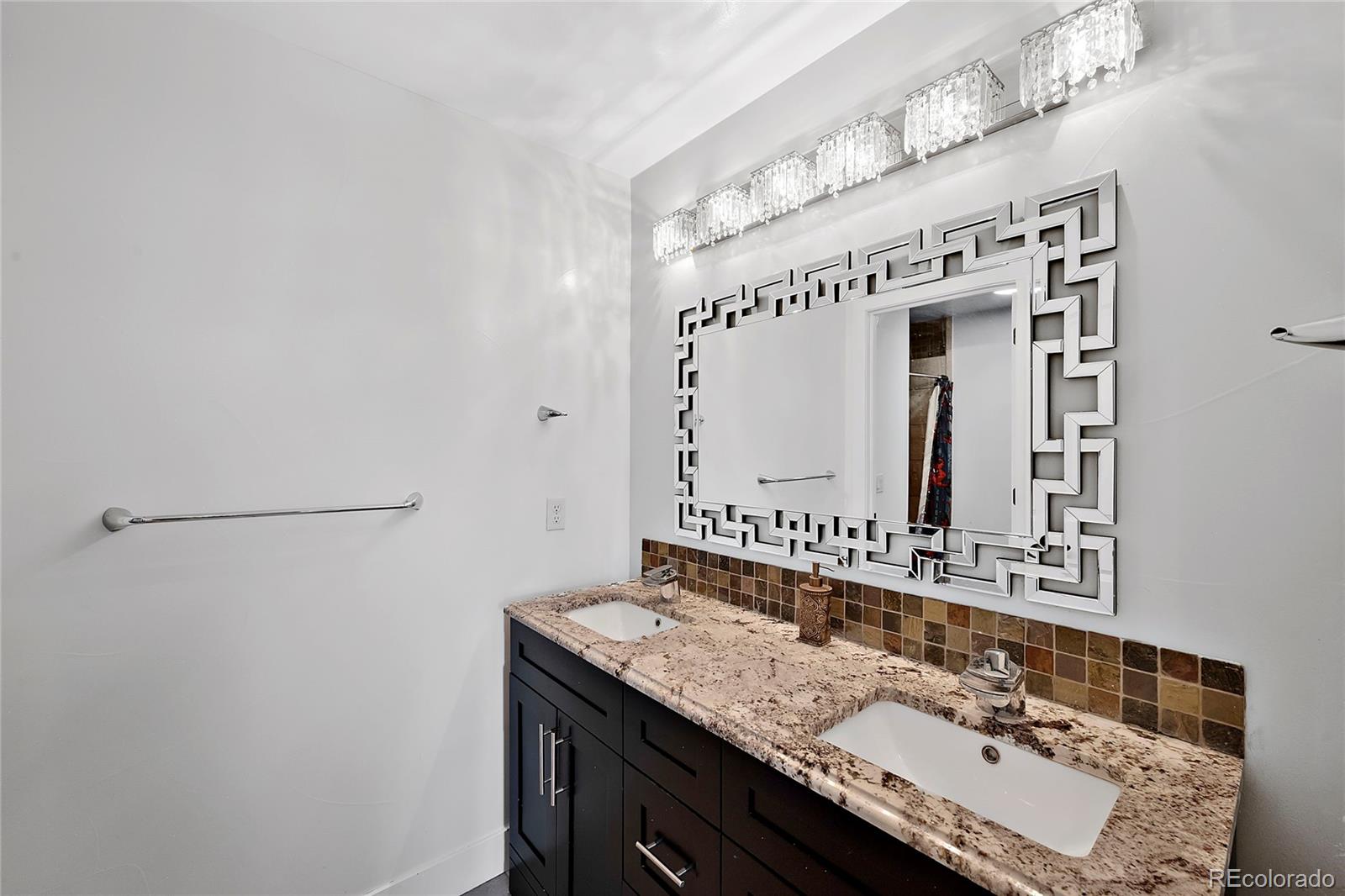 16520 East Easter Way Foxfield, CO 80016 - Photo 31 of 38 a bathroom with a sink and a mirror
