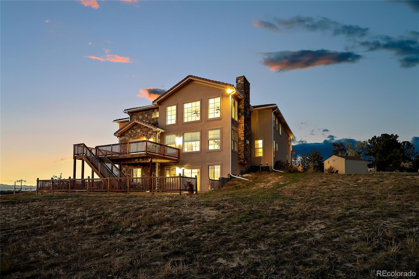16520 East Easter Way Foxfield, CO 80016 - Photo 37 of 38 a view of a large house with a yard