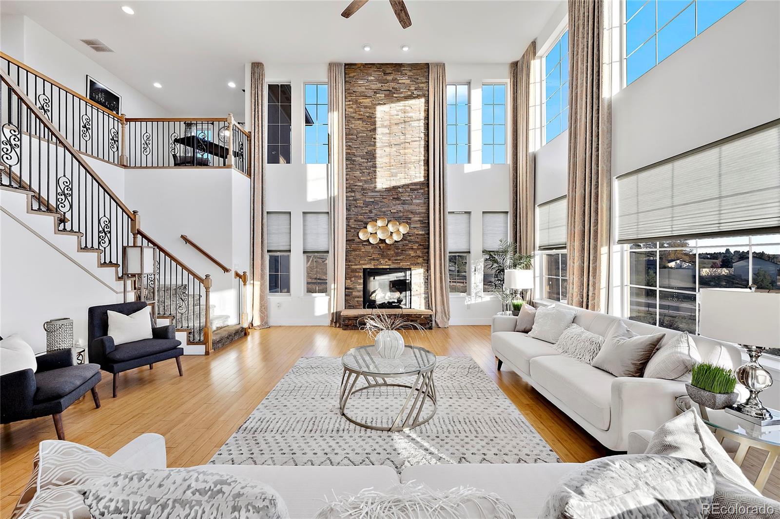 16520 East Easter Way Foxfield, CO 80016 - Photo 4 of 38 a living room with furniture large windows and glass table