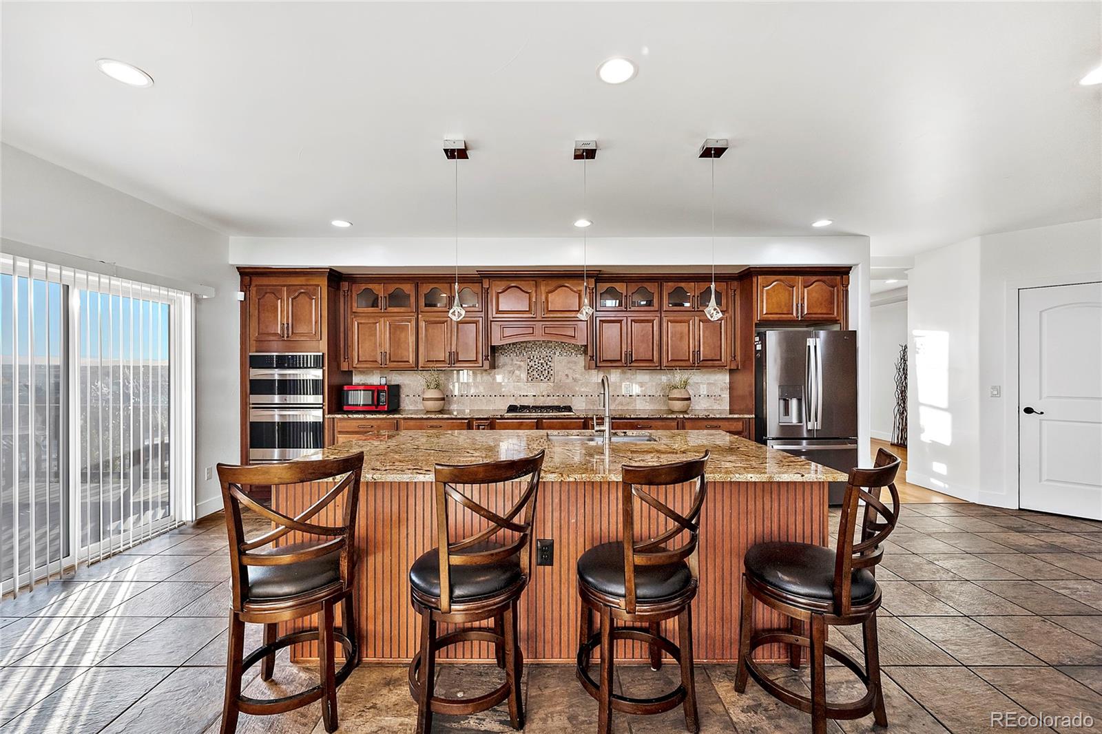 16520 East Easter Way Foxfield, CO 80016 - Photo 7 of 38 a dining area with furniture and a large window