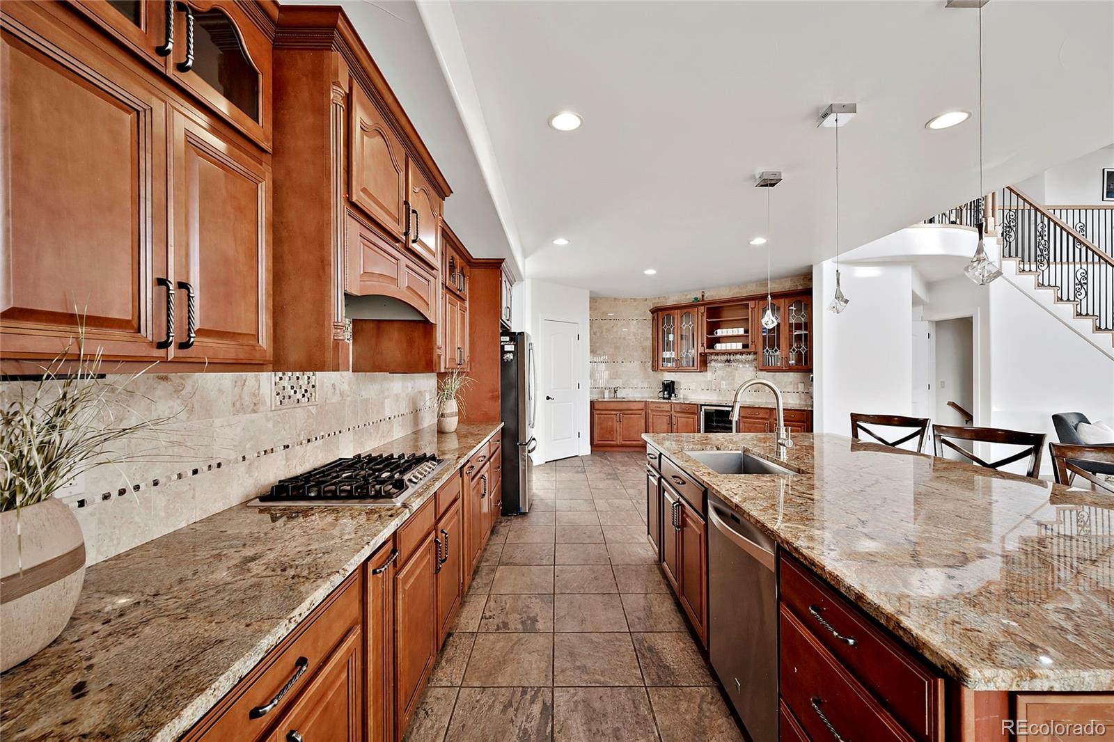 16520 East Easter Way Foxfield, CO 80016 - Photo 8 of 38 a kitchen with stainless steel appliances granite countertop a stove a sink and a refrigerator