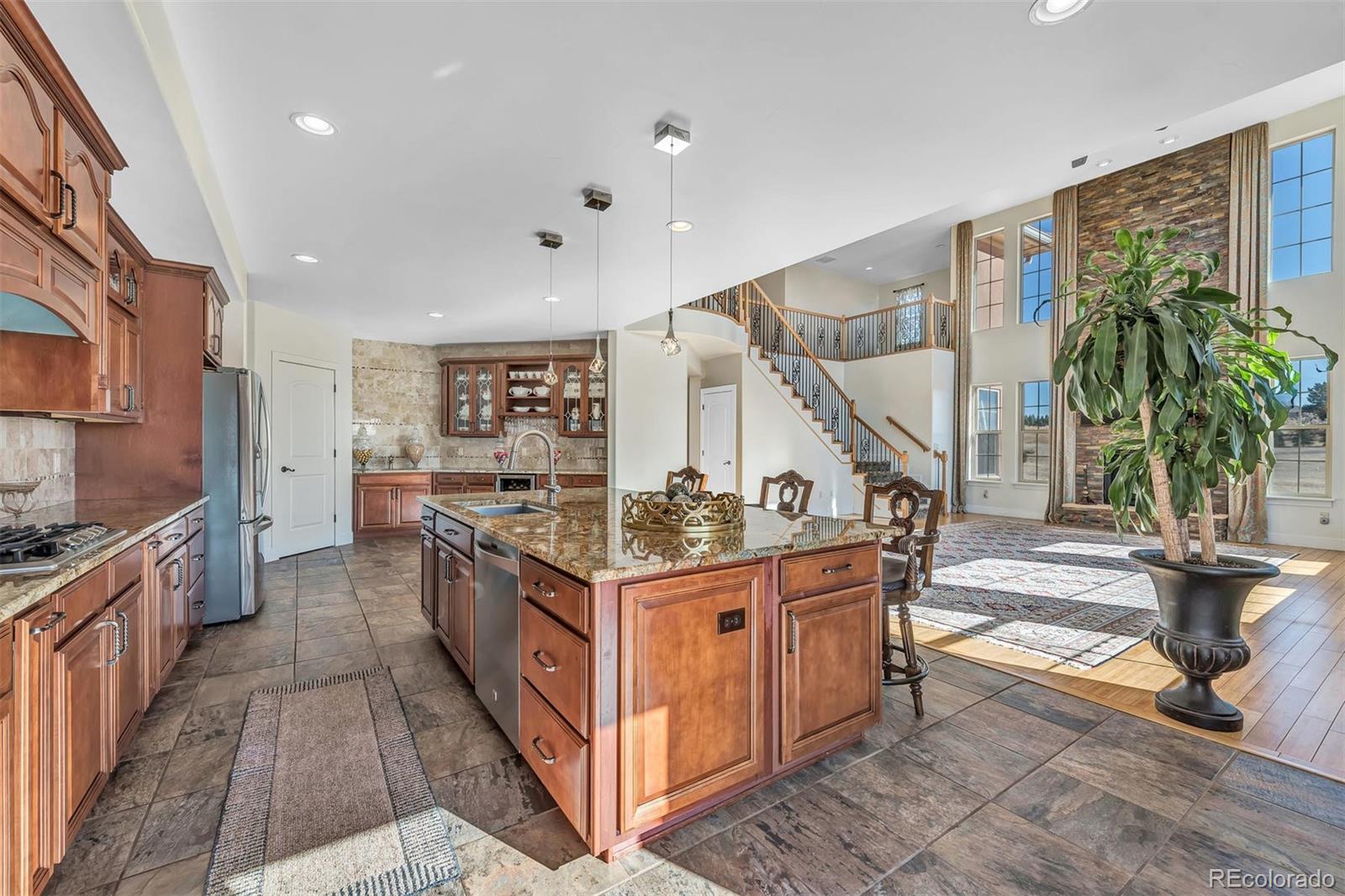 16520 East Easter Way Foxfield, CO 80016 - Photo 10 of 38 a kitchen with stainless steel appliances granite countertop a stove and a sink