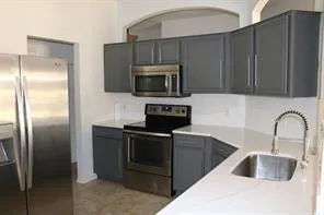 a kitchen with a refrigerator sink and microwave