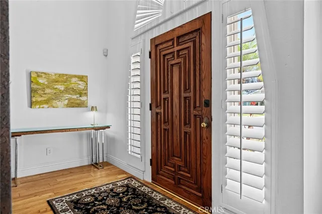 a view of entryway and hall with wooden floor