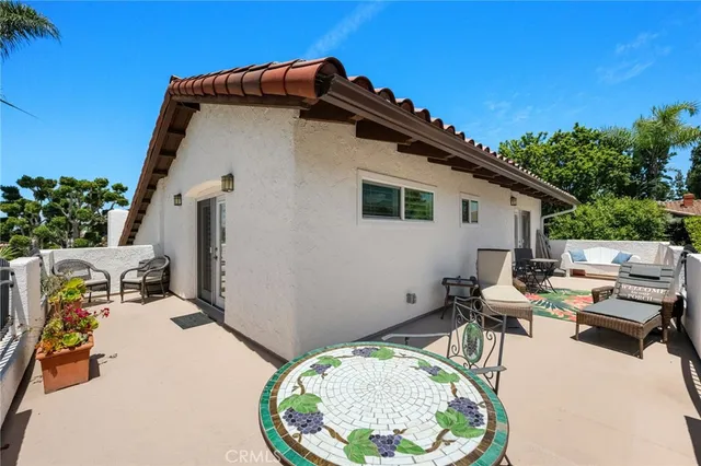 a bedroom with a bed a dresser and wooden floor