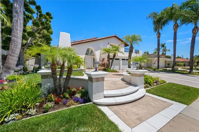 a view of a house with palm trees and plants