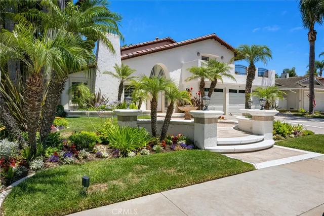a view of a house with a yard and potted plants