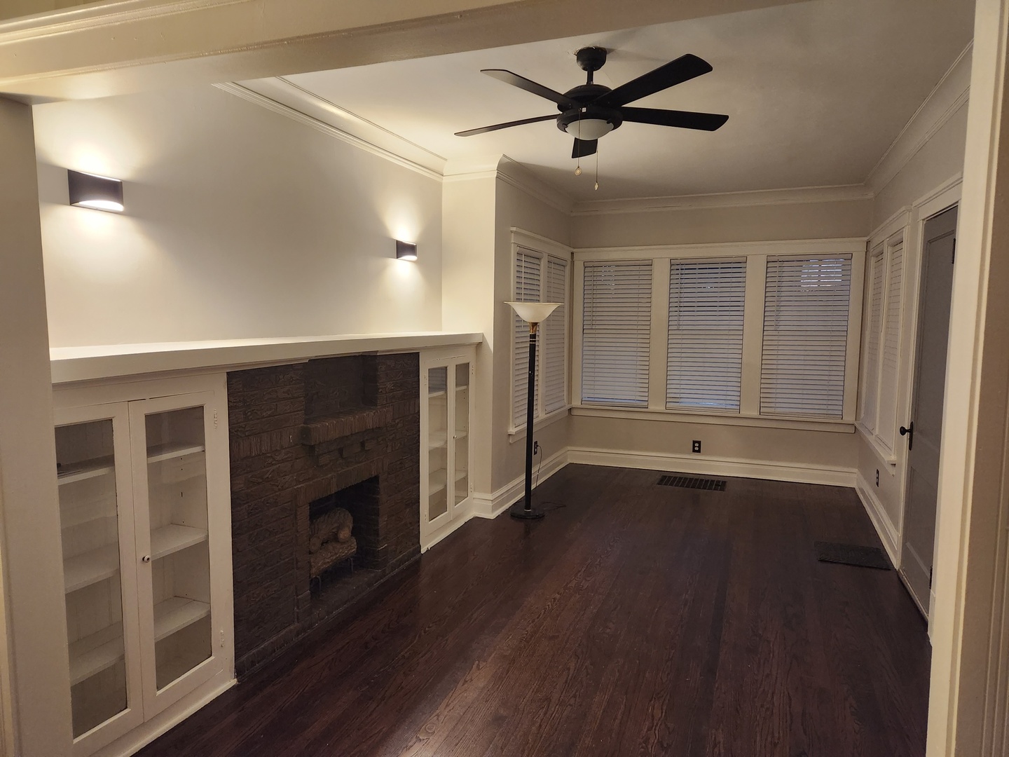 7443 South Wabash Avenue Chicago, IL 60619 - Photo 2 of 10 a view of a livingroom with a fireplace a ceiling fan and wooden floor