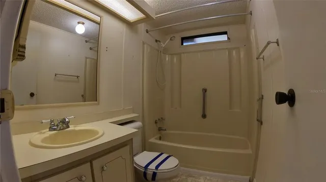a bathroom with a sink toilet tub and shower